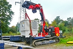 An articulated Fassi crane model F1300RA on crawler vehicle